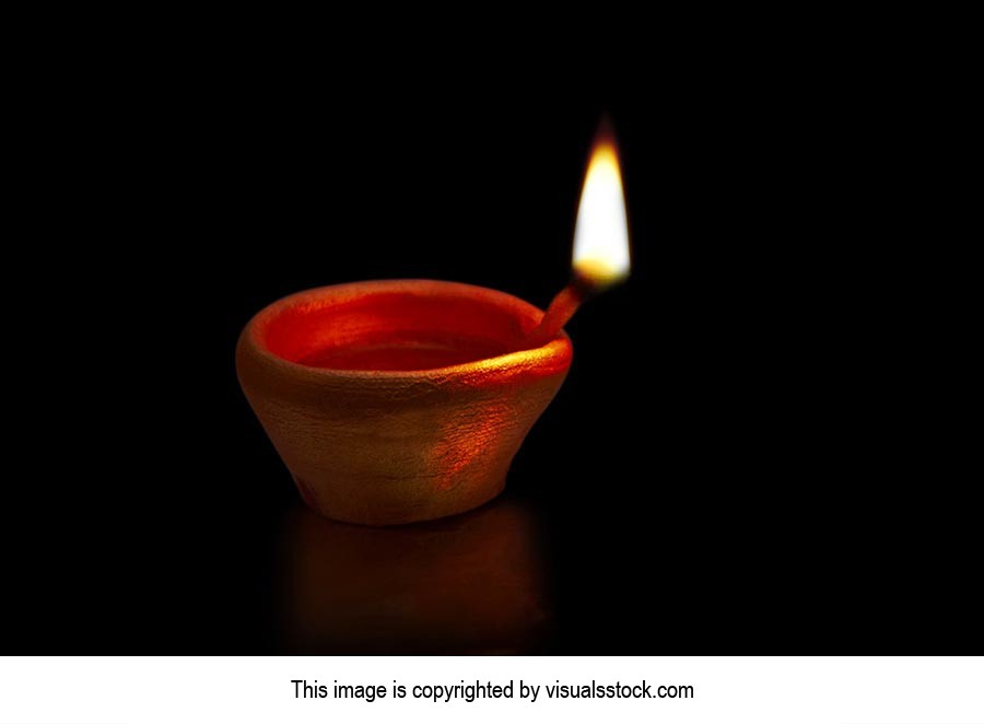 Closeup-Of Burning diya oil-lamp Isolated on-Black Background on-Diwali  Festival