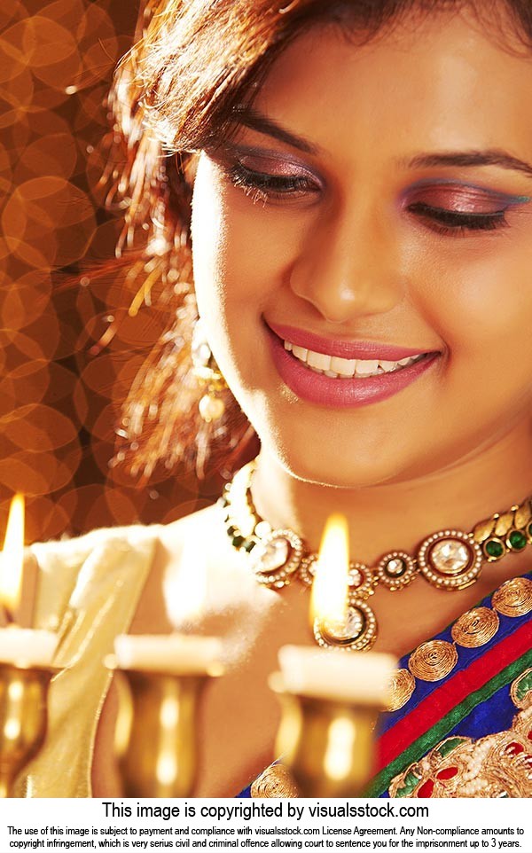 Woman Lighting Diwali Lamp