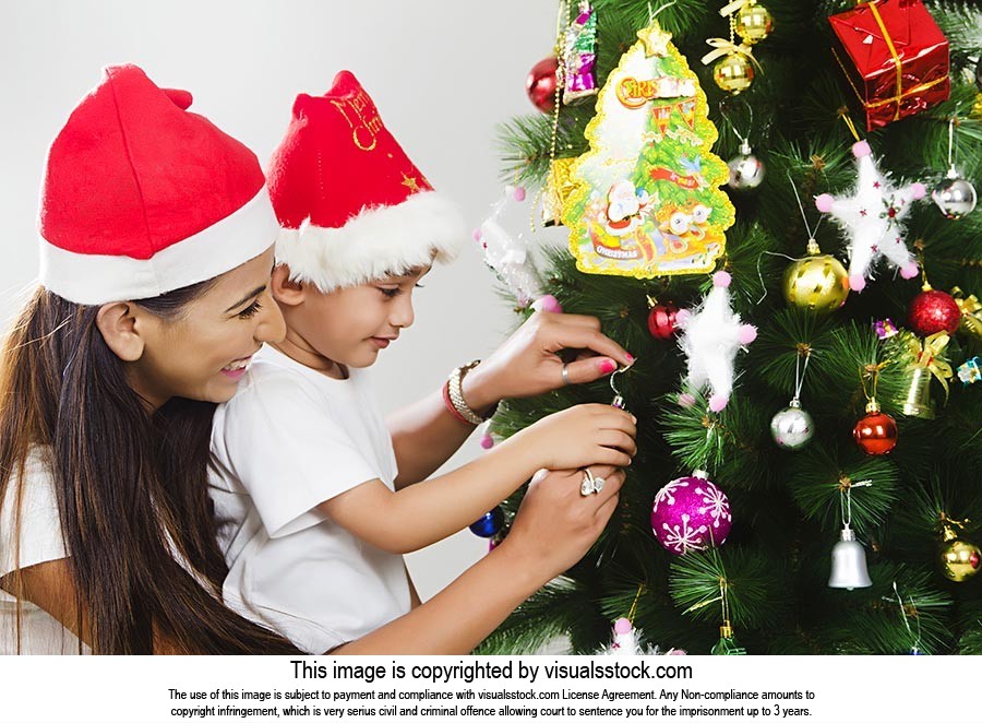 Indian Mother Child Son decorating Christmas tree