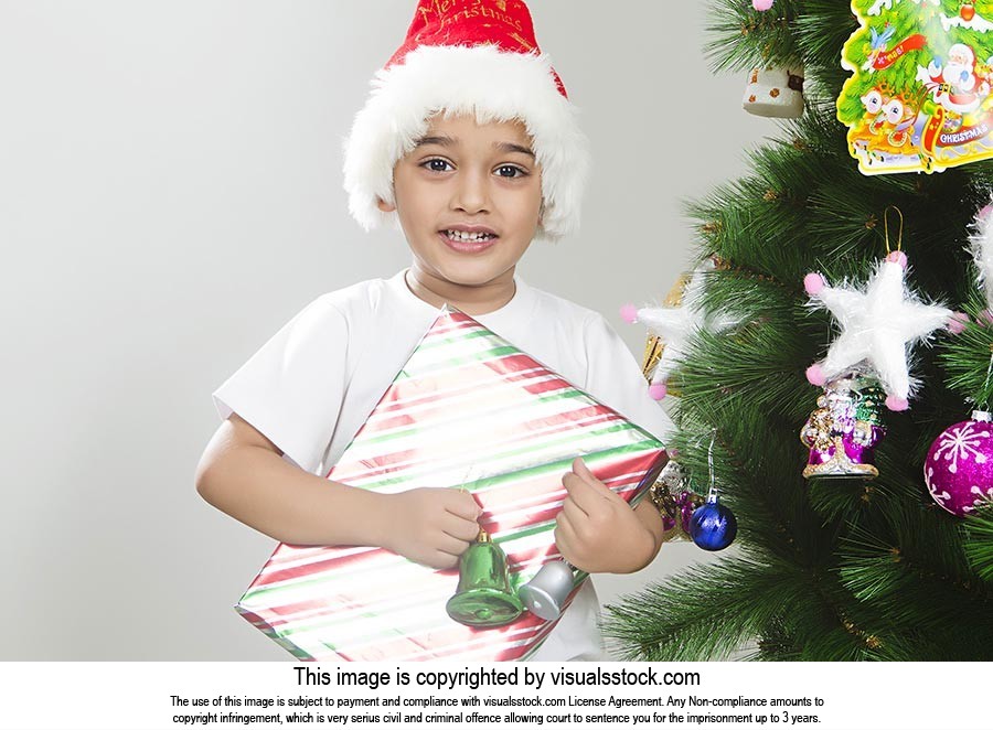little boy celebrates Christmas Tree presents gift