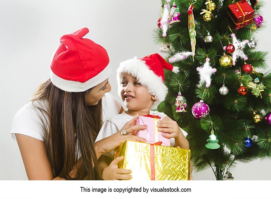 Indian Son Receiving Christmas Gift Mother Smiling