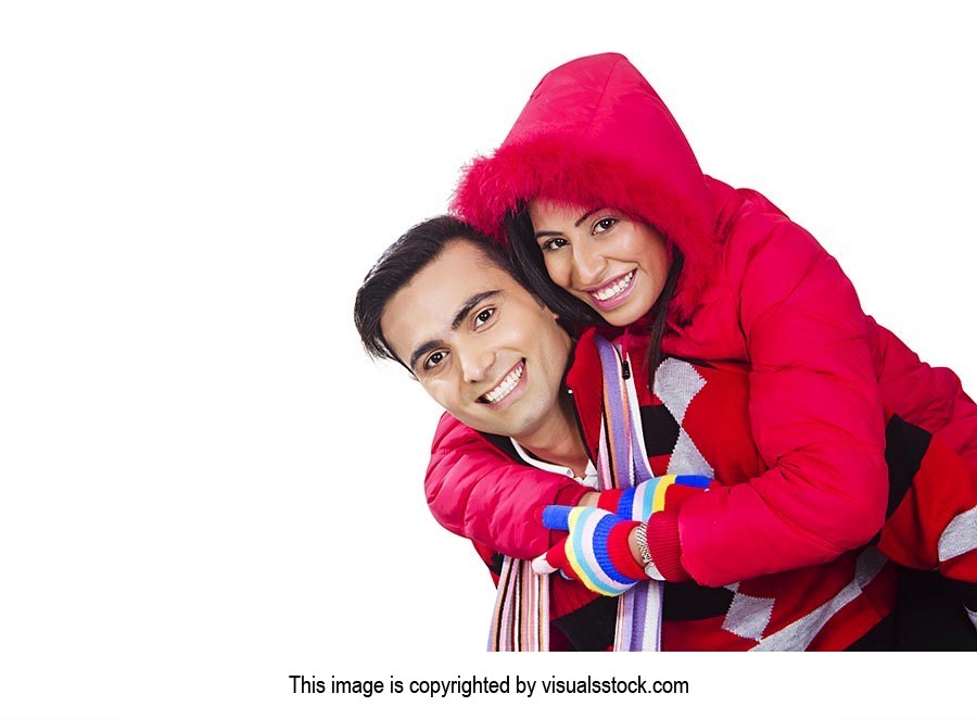 couple winter clothes playing piggyback Fun Smilin