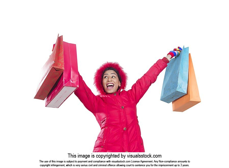 Excited Woman Winter Clothe carrying Shopping Bags