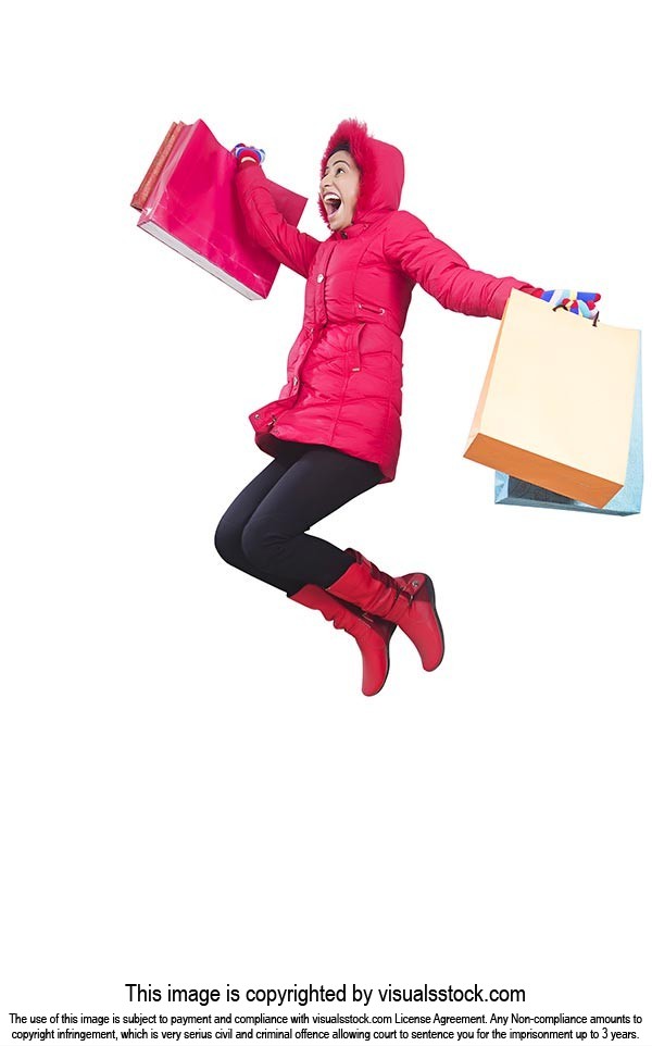 Cheerful Woman carrying shopping bags jumping mid 
