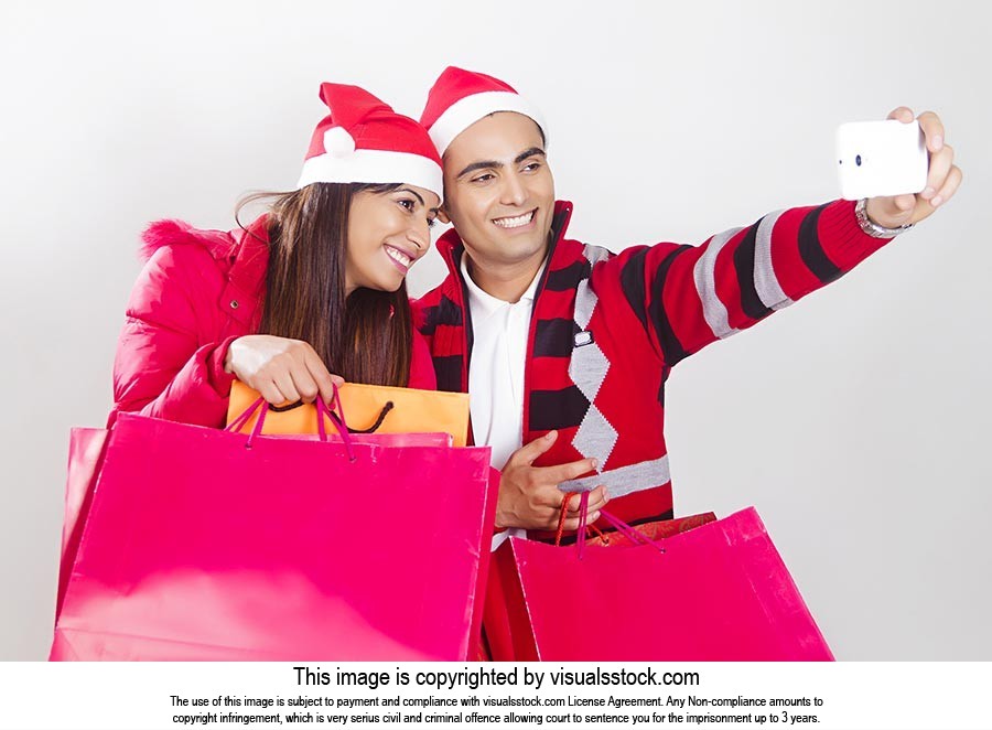 Couple Christmas Shopping Bags Taking Selfie Phone