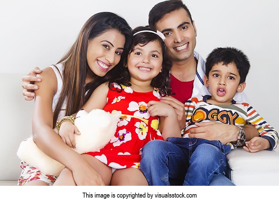 Indian Parents Children Sitting Sofa Smiling