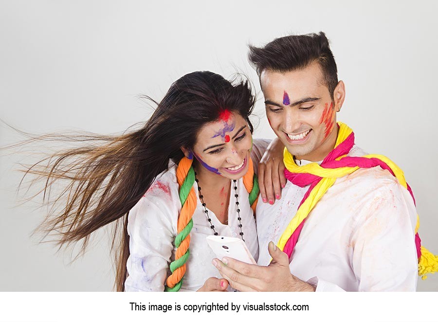 Couple Holi Celebration Fun Reading Messaging Cell