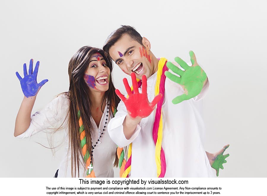 Cheerful Couple showing colored hands Holi Celebra