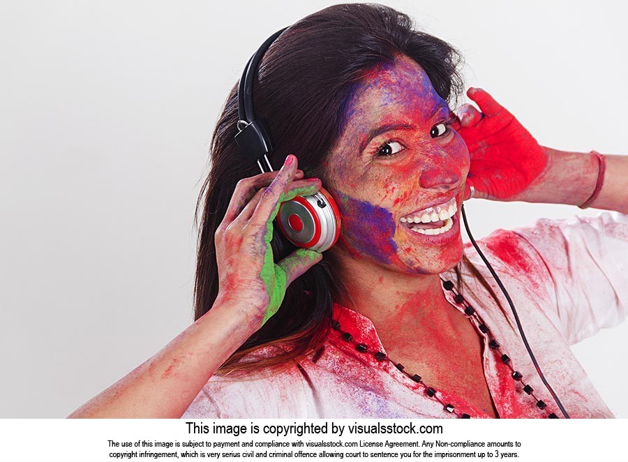 Woman Holi Celebrating listening music headphone