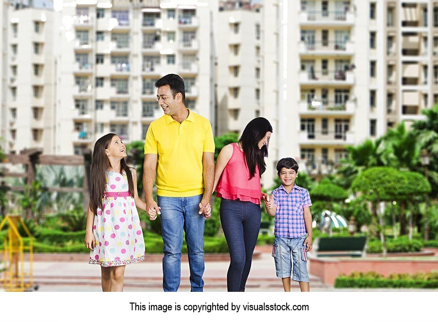 Indian Parents Standing Outside Apartment