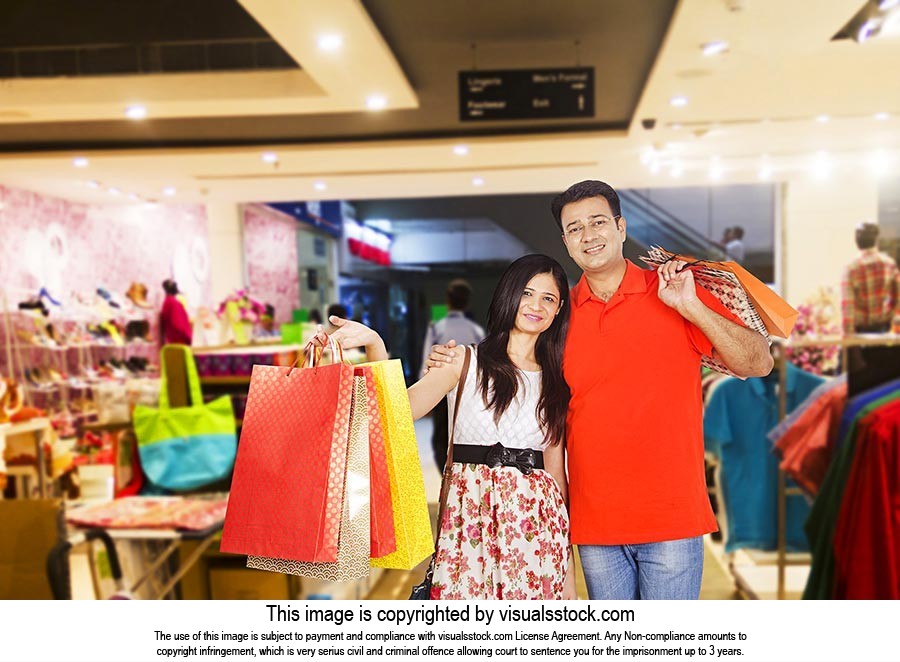Happy Indian Couple Holding Shopping Bags