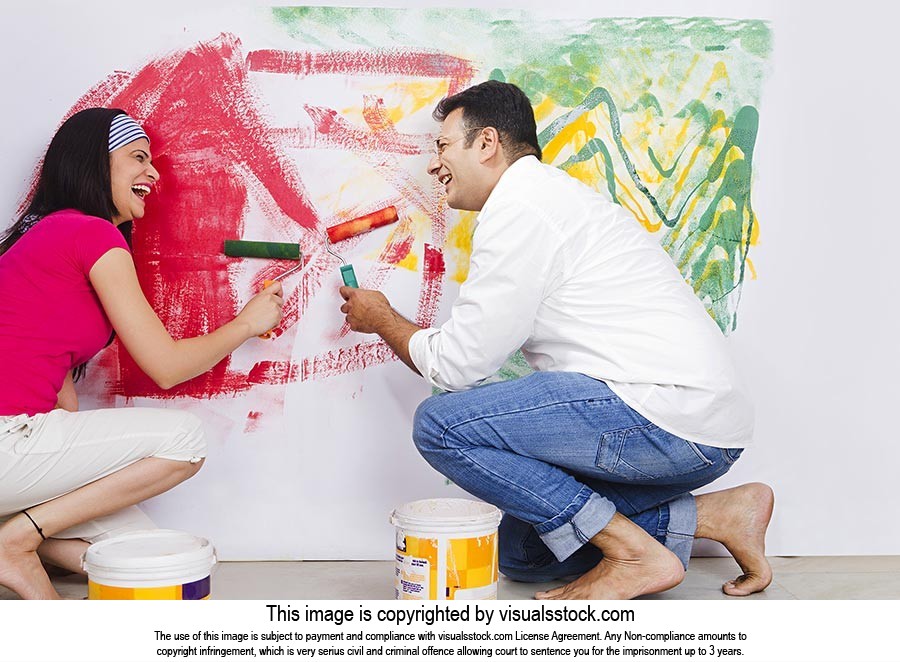 Couple Painting Wall Home Improvement