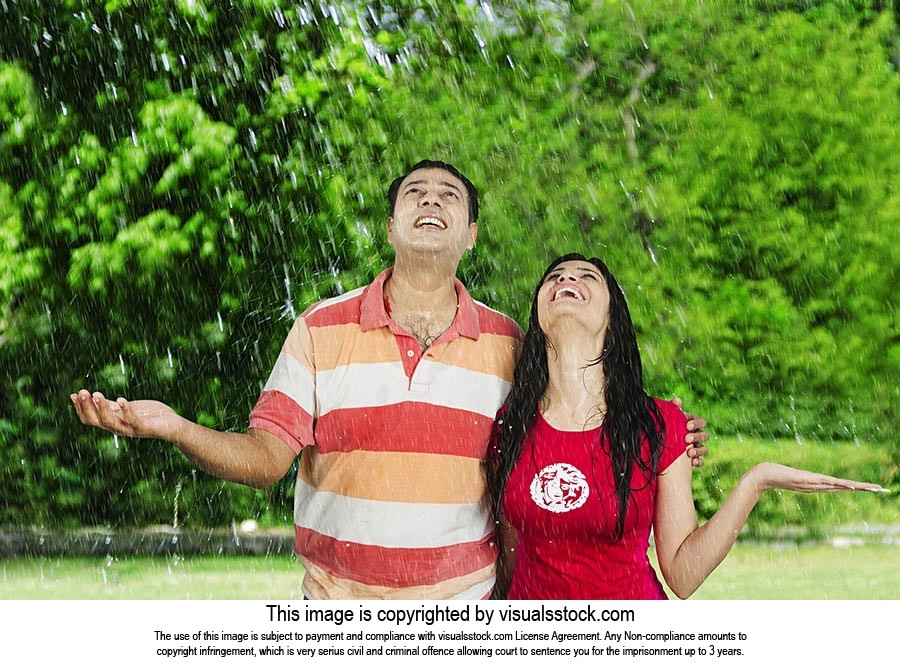 Indian Couple Enjoying Rain Park