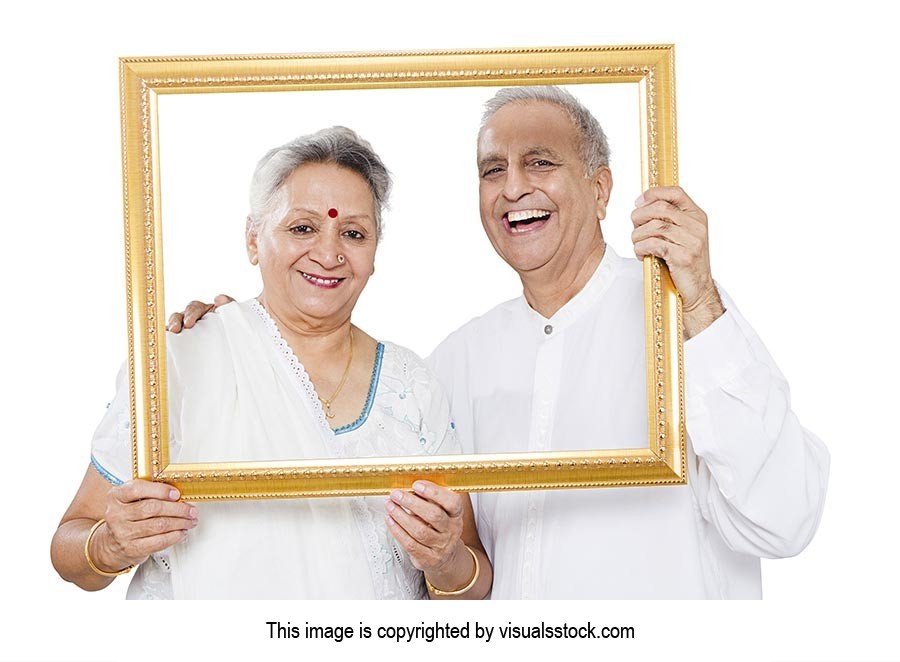 Senior Couple Holding Photo Frame