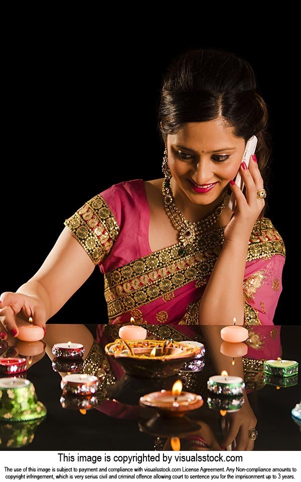 Woman Arranging Diya Talking Phone Diwali Festival
