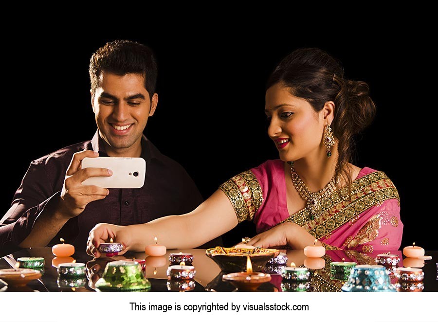 Couple Lighting Diyas Clicking Picture