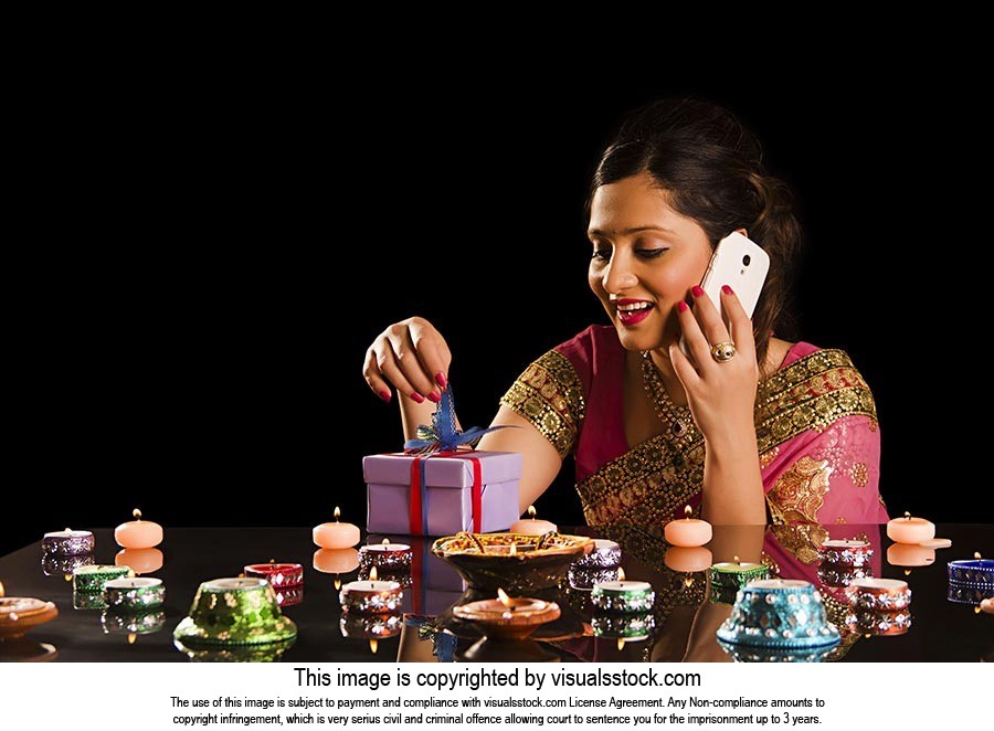 Woman Opening Gift Box Talking Phone Diwali