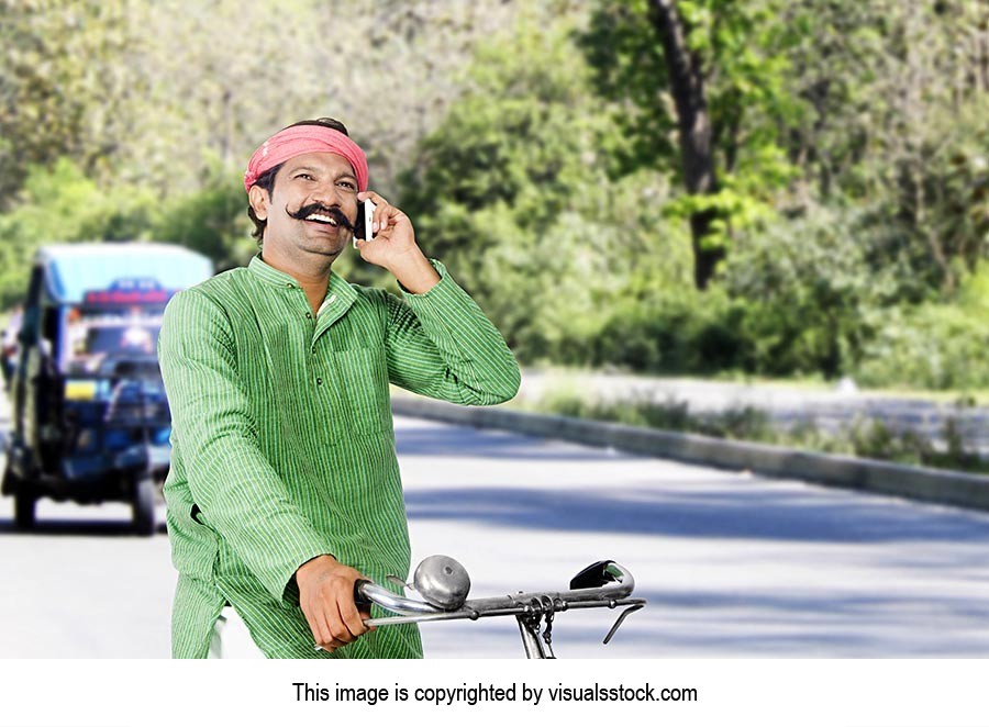 Rural Man Riding Bicycle Talking Phone