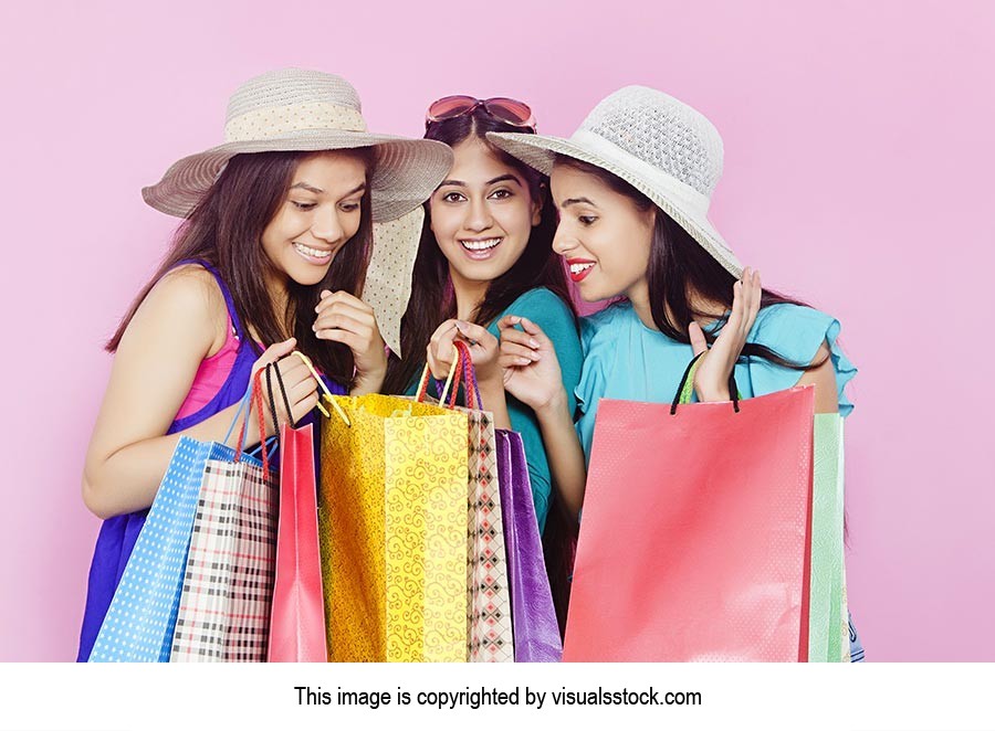 Young Girls Opening Shopping Bag