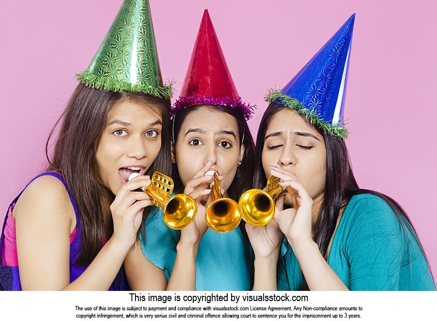 Teenage Girls Blowing Party Horn