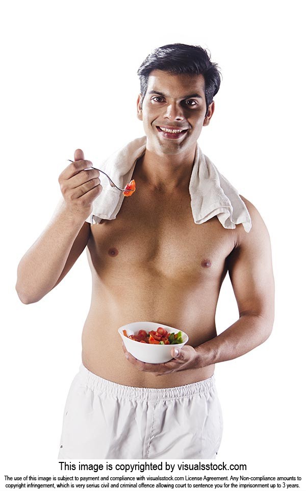 Fitness Bodybuilder Man Eating Fresh Salad