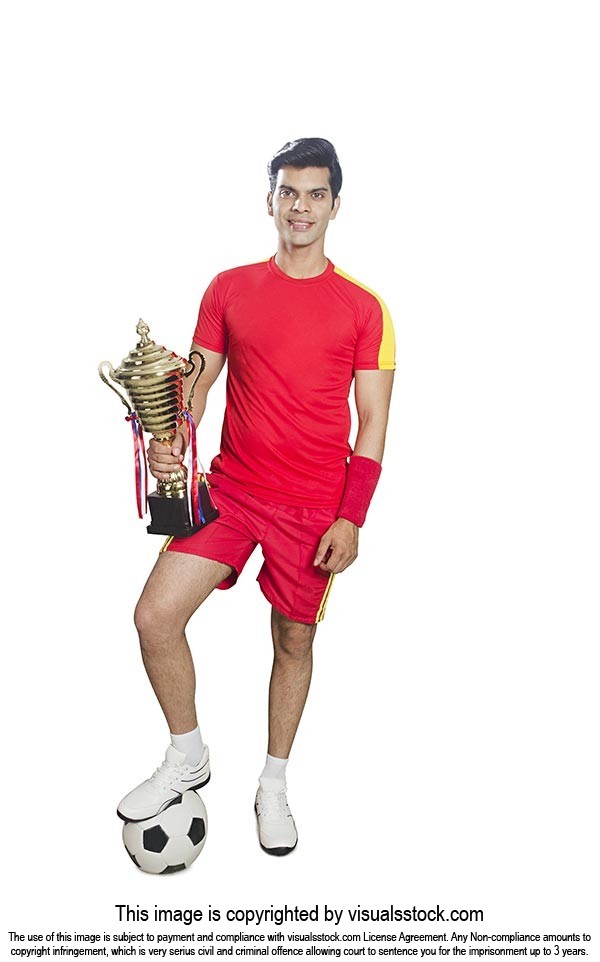 Man Football Player Holding Trophy Triumphantly