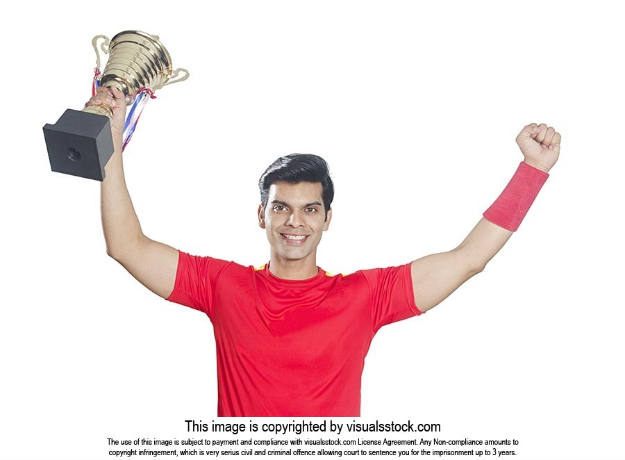 Soccer Player Holding Trophy Triumphantly