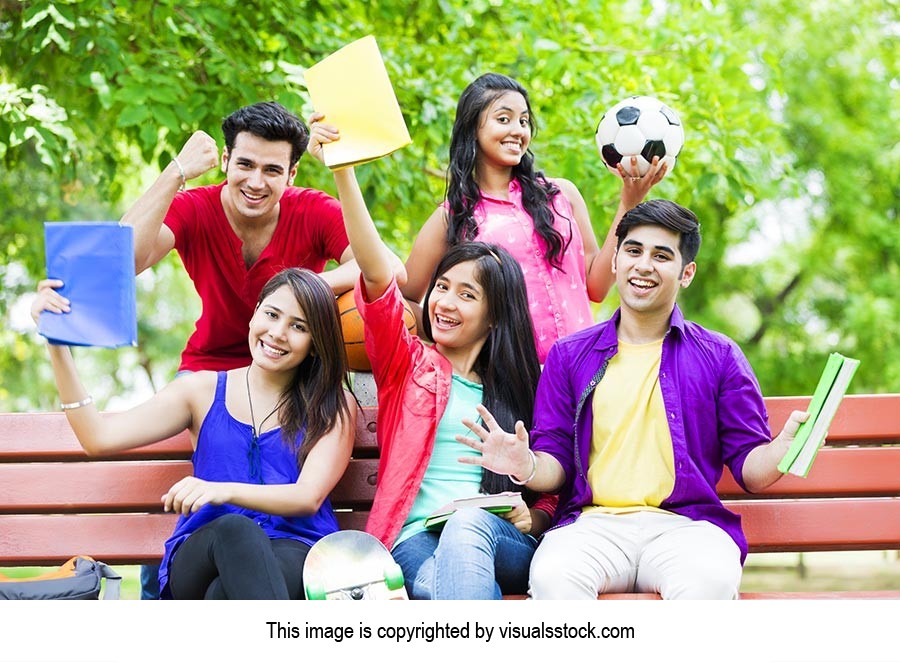 College students sitting in park  Celebrating succ