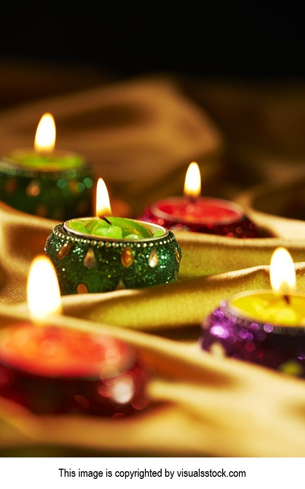 Arranging ; Black background ; Burning ; Candles ;