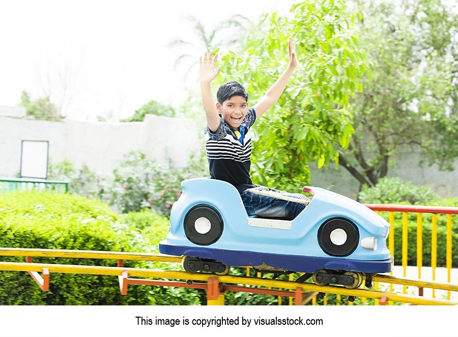 1 Person Only ; Amusement Park ; Arms Raised ; Boy