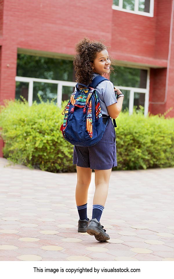 Young School Girl Student carrying his backpack Turning Looking at camera And going School