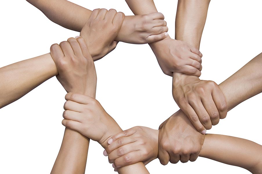 Group of people holding hands on-white background Unity concept
