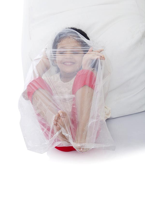 Happy Kid Girl Wrapped Covering Plastic Bag Having FunEnjoy