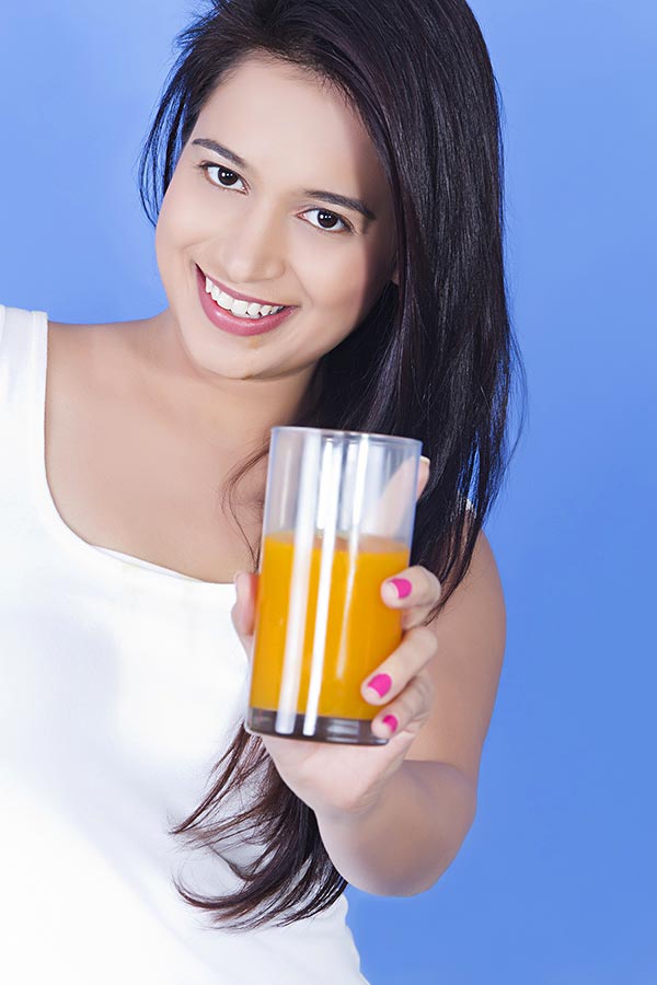 Happy Youngwoman showing orange Ormango Juice Healthy Lifestyle Concept