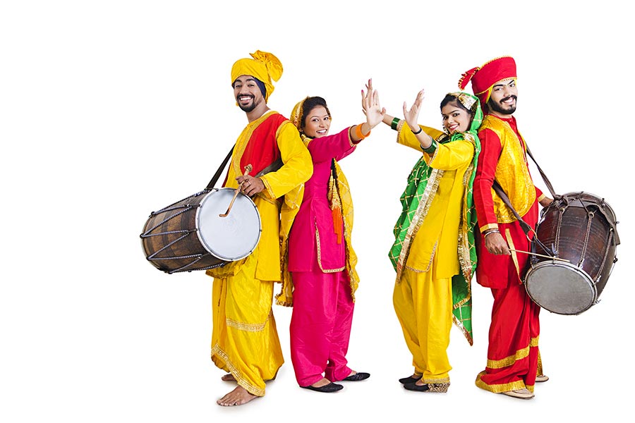 Sikh Punjabi Sardar Two-couples playing dhol and dancing bhangra on