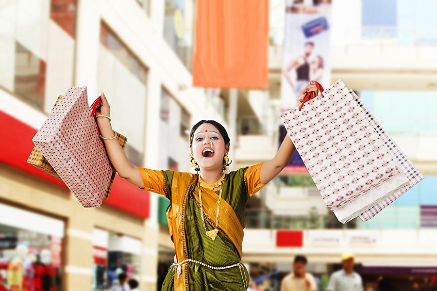 Happy Traditional Indian Marathi woman Carrying Shopping bags in