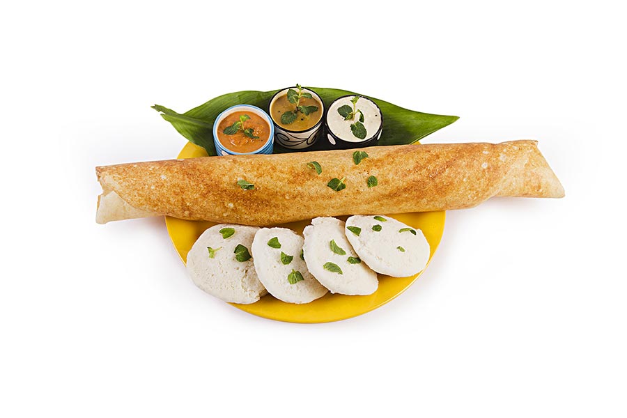 SouthIndian Vegetarian meal paper Masala Dosa chutney and sambar inPlate