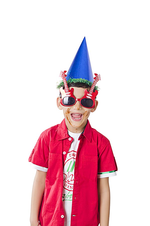 Happy Shouted KidBoy Wearing Birthday Hat With Goggles Celebrating