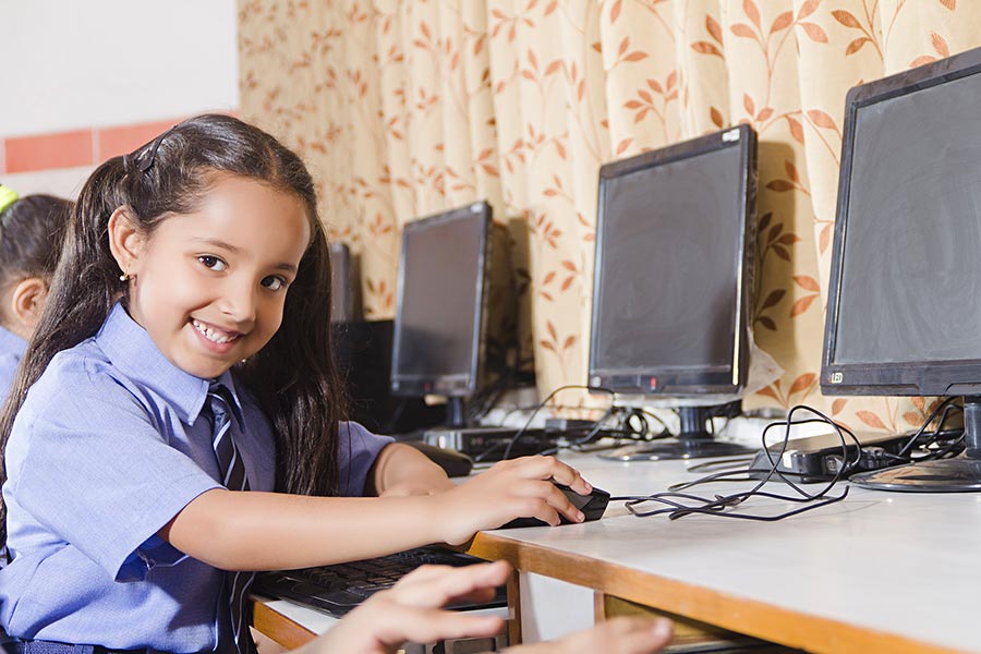 Indian PrimarySchool Kid Girl Student Using Computer Studying E