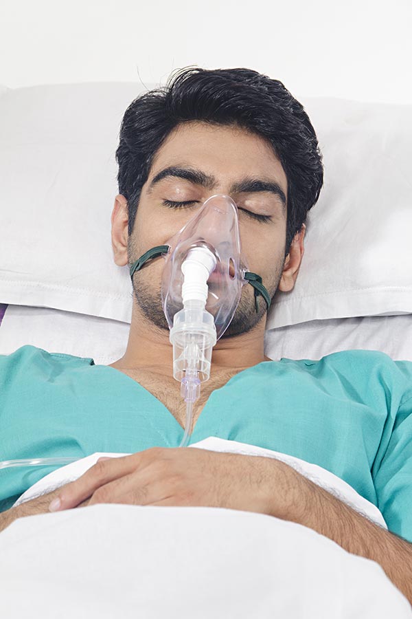 Man Patient Wearing Oxygen Mask While Sleeping OnBed inhospital