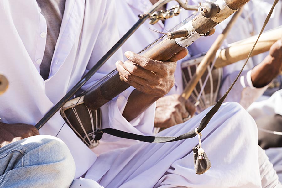 Rajasthani folk musicians playing musical instrument harmonium violin