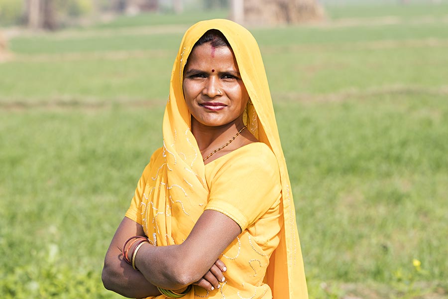Smiling Indian Rural Woman Arms Crossed Standing In Farm Village