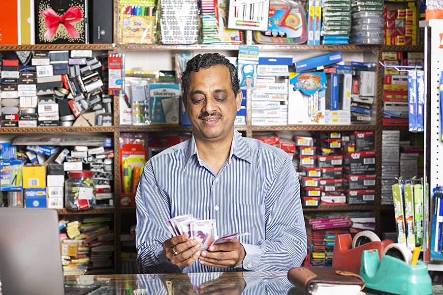 1 Indian Shopkeeper Man Counting Rupees Notes In Stationary Store