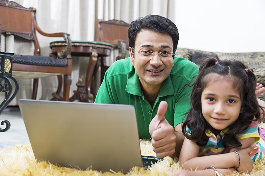 Indian Father And Kid Daughter Using Laptop Showing Thumbeup Athome