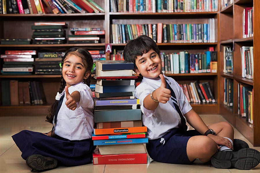 Indian School Kids Studets Friend Sitting In Library Showing Thumbs Up