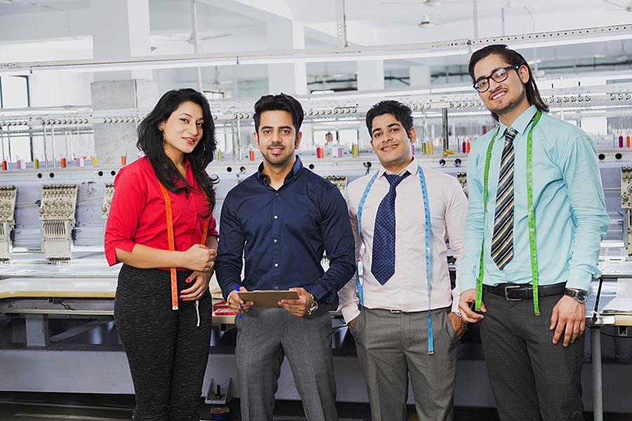 Clothing Factory Supervisor With Workers Working in Textile Industry