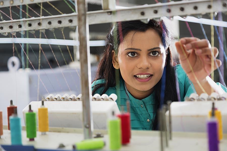 Concentrate YoungWoman TextileFactory Worker Using Embroidery Machine