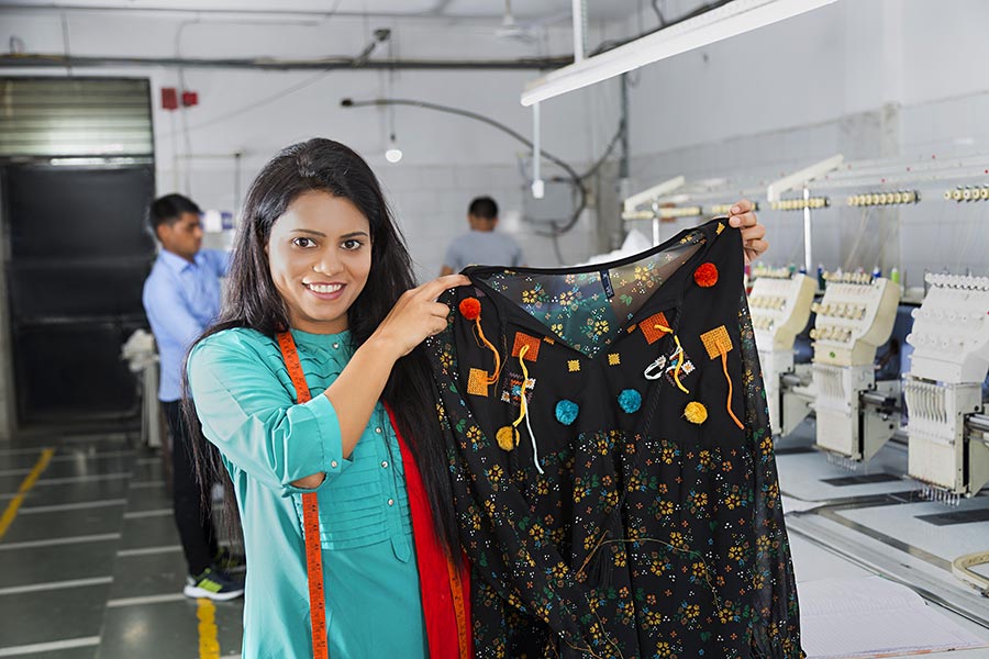 Woman Textile Factory Worker Employee Showing Top Working inTextile