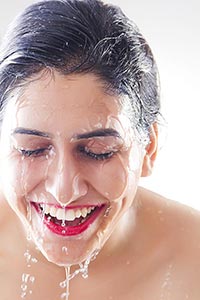 Beautiful woman washing Cleaning face water Smilin