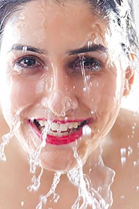 Beautiful woman washing Cleaning face water Smilin